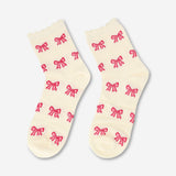 Pair of white textile socks with pink bows for size 39/41 from Flying Tiger Copenhagen, showing the detailed bow embellishments.