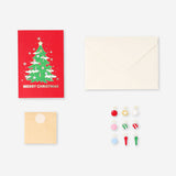 Flying Tiger Copenhagen Christmas office card featuring a decorated Christmas tree with colorful ornaments and festive design.