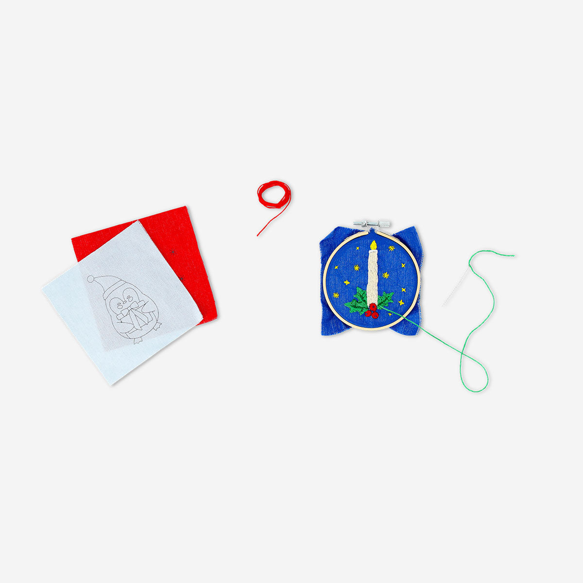Christmas-themed embroidery kit by Flying Tiger Copenhagen, featuring colorful threads, fabric, and embroidery supplies for holiday crafts.