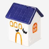 Decorative ceramic Halloween house in black and orange, 13 cm tall, from Flying Tiger Copenhagen, with spooky window details.
