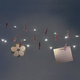 Purple string lights with clips from Flying Tiger Copenhagen, ideal for home decor and ambient lighting.