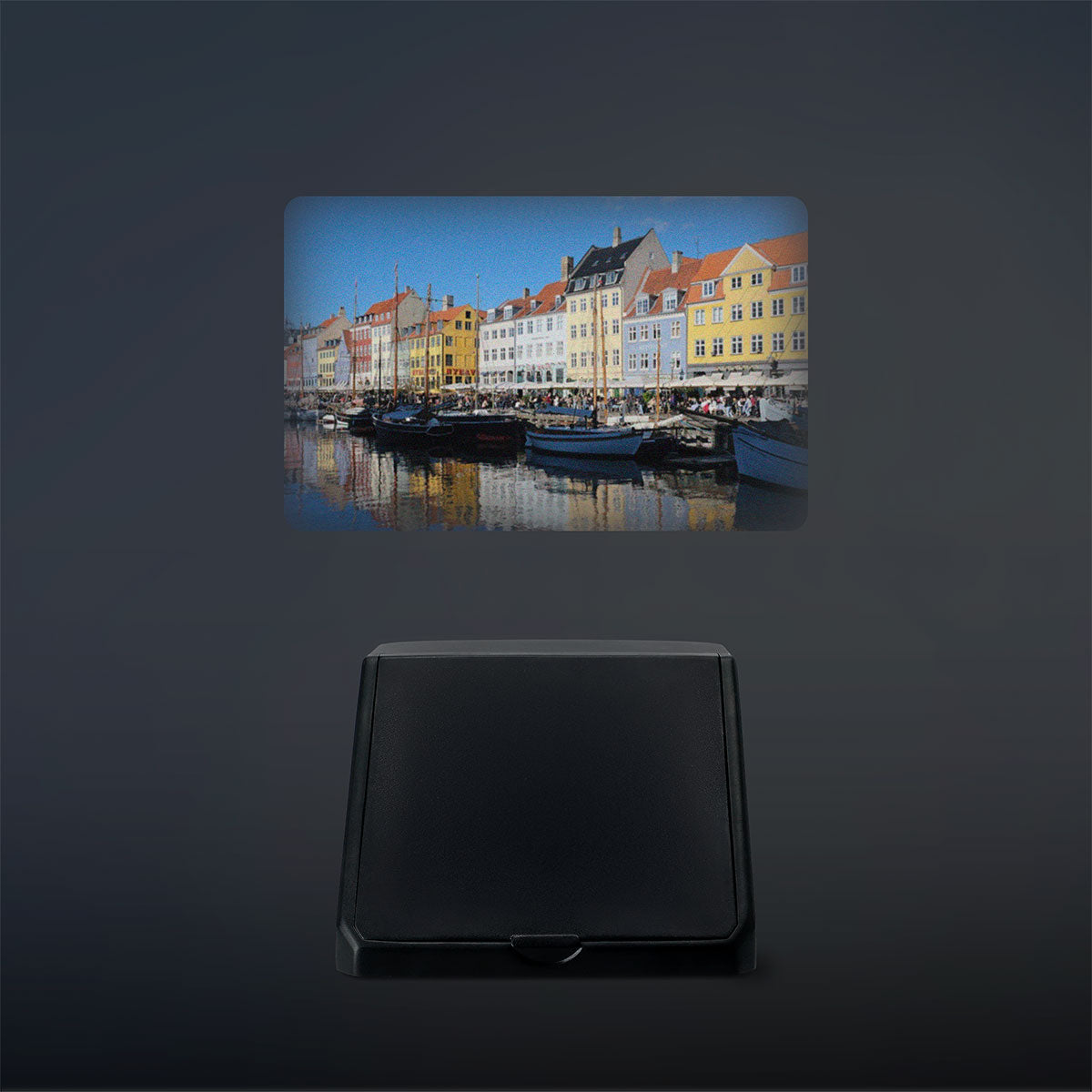 Flying Tiger Copenhagen retro smartphone projector displaying images on a wall, compact media device for home entertainment.