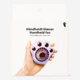 Purple handheld fan with paw design, Flying Tiger Copenhagen gadget, compact and portable for cooling on the go.