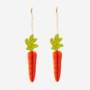 Two hanging honeycomb paper carrots for party decorations by Flying Tiger Copenhagen, featuring vibrant orange and green colors.
