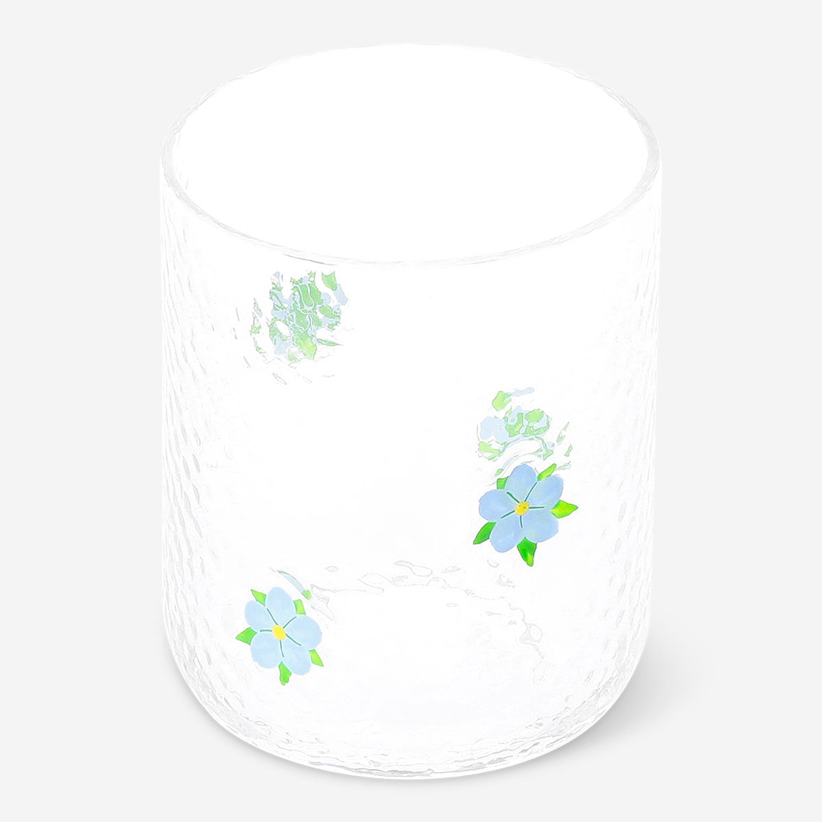 Blue embossed floral drinking glass from Flying Tiger Copenhagen, 340 ml, with intricate flower patterns in a clear glass design.