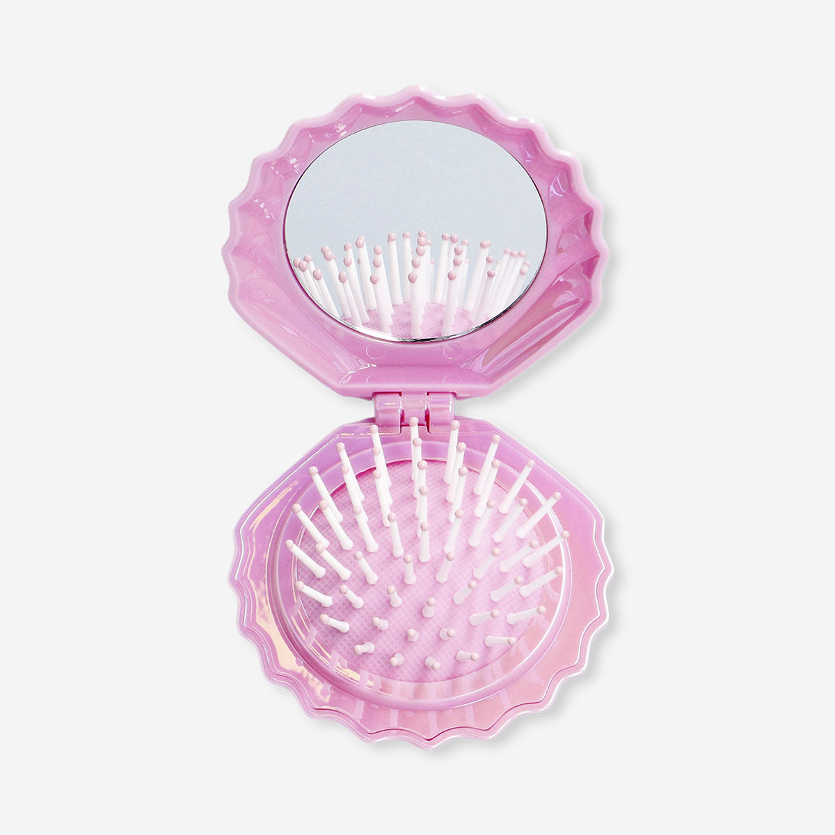 Pink clamshell hairbrush and mirror from Flying Tiger Copenhagen for personal care, with a compact, stylish design.