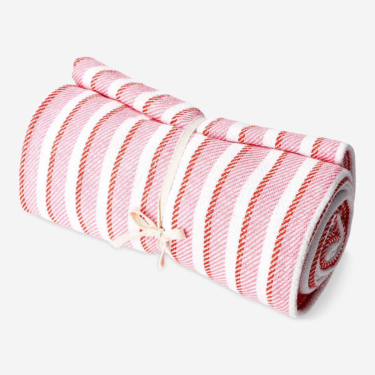 Pink striped throw blanket with fringes, 120x170 cm, from Flying Tiger Copenhagen, shown draped on a cozy sofa.