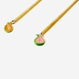 Set of two gold dessert spoons with colorful fruit decorations, ideal for elegant kitchen serving and dessert presentation.