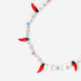 Flying Tiger Copenhagen Chilli phone charm hanging from a phone, colorful and playful accessory for mobile devices.