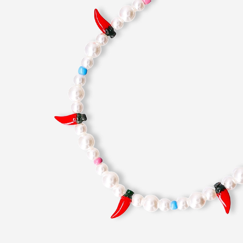 Flying Tiger Copenhagen Chilli phone charm hanging from a phone, colorful and playful accessory for mobile devices.