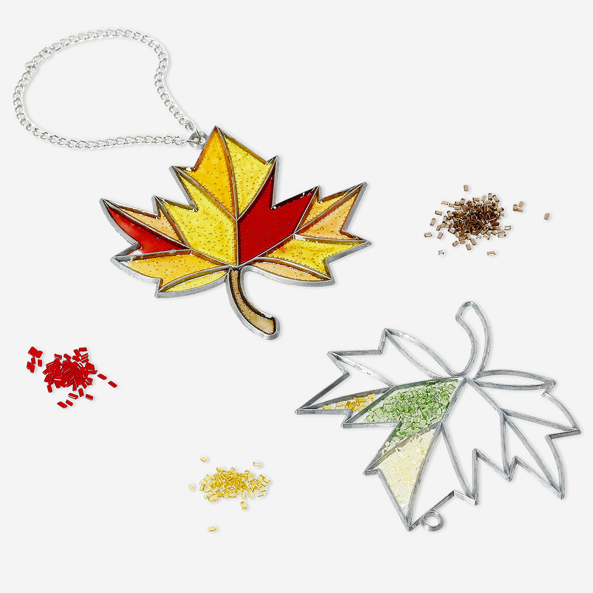 Two DIY stained glass autumn leaves decorations for hanging, featuring vibrant fall colors and intricate glasswork by Flying Tiger Copenhagen.