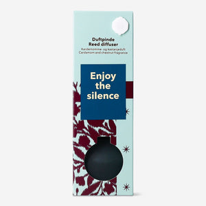 Flying Tiger Copenhagen reed diffuser featuring cardamom and chestnut scent, with elegant glass bottle and natural reed sticks.
