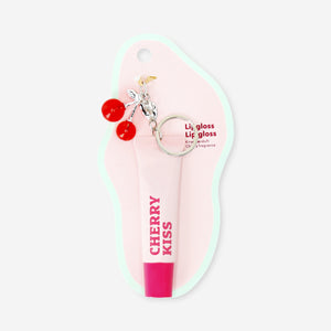 Flying Tiger Copenhagen cherry scented lip gloss with a charm, featuring a shiny, smooth finish and a decorative charm attachment.