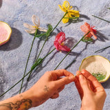 Colorful DIY beaded flower craft kit from Flying Tiger Copenhagen, featuring vibrant beads and floral design for hobbies and creative projects.