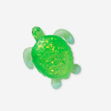 Green turtle Press Me toy gadget from Flying Tiger Copenhagen, featuring a soft, squeezable turtle design for fun and sensory play.