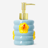 Ceramic soap dispenser with hibiscus flower print, home decor by Flying Tiger Copenhagen, featuring a colorful, floral design.
