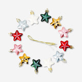 Set of 12 Flying Tiger Copenhagen star-shaped decorative baubles for home decor, featuring colorful and shiny finishes.