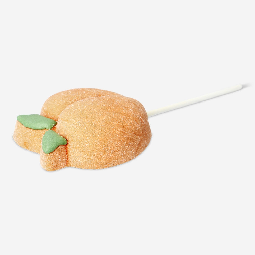Peach-flavored marshmallow on a stick from Flying Tiger Copenhagen, showcasing a soft, fluffy marshmallow coated in peach flavor.