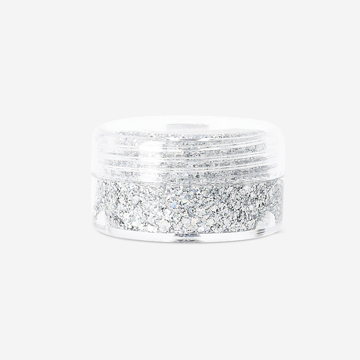 Silver glitter eyeshadow flakes from Flying Tiger Copenhagen, close-up of shimmering, iridescent cosmetic flakes for eye makeup.