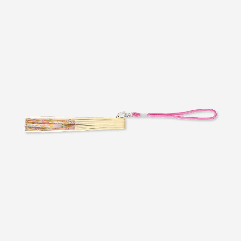 Foldable bamboo fan with flower print and strap, textile material, by Flying Tiger Copenhagen, shown open with detailed floral design.
