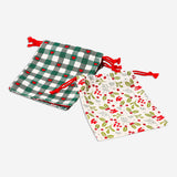 Four Christmas print drawstring gift bags from Flying Tiger Copenhagen, festive office gift packaging with colorful holiday designs.
