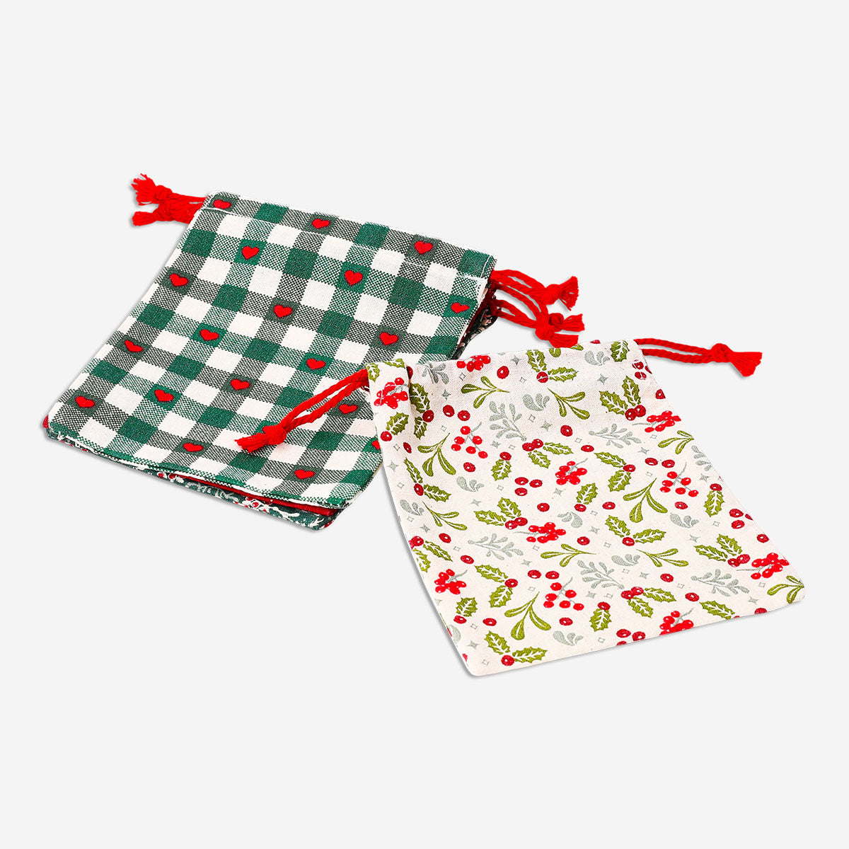 Four Christmas print drawstring gift bags from Flying Tiger Copenhagen, festive office gift packaging with colorful holiday designs.