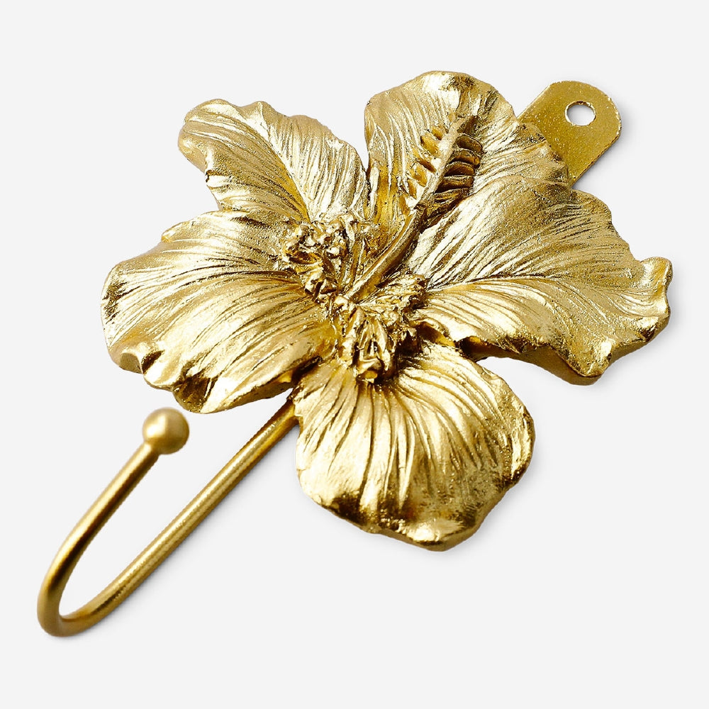Gold flower-shaped hook from Flying Tiger Copenhagen for home decor and organization.