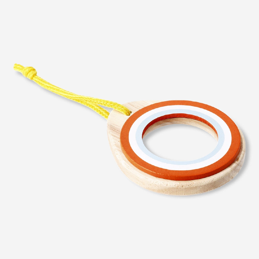 Wooden toy magnifying glass from Flying Tiger Copenhagen, with a circular wooden handle and clear glass lens for exploring.