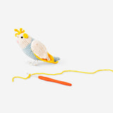 DIY crochet tropical bird hobby kit by Flying Tiger Copenhagen featuring colorful crochet bird craft in vibrant tropical style.
