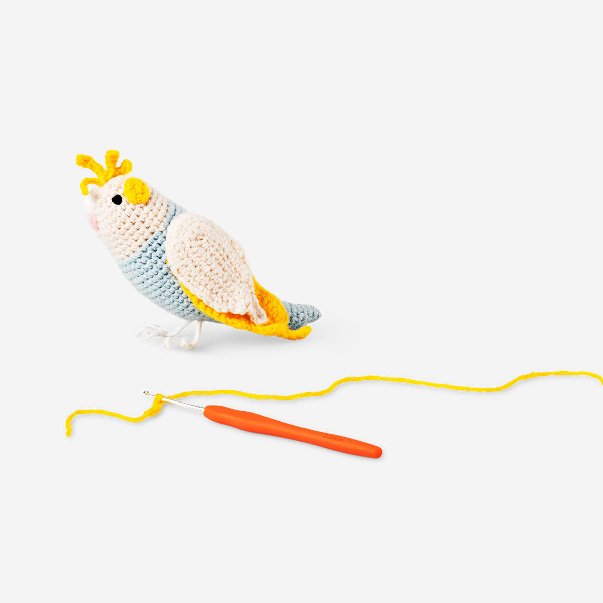 DIY crochet tropical bird hobby kit by Flying Tiger Copenhagen featuring colorful crochet bird craft in vibrant tropical style.