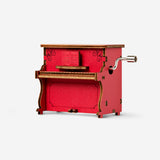 Flying Tiger Copenhagen DIY music box gadget with colorful components and small mechanical parts on a white background.