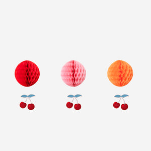 Three honeycomb paper cherries in red and green, decorative party embellishments by Flying Tiger Copenhagen.