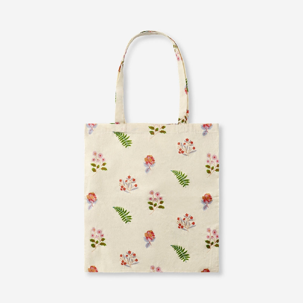 Flying Tiger Copenhagen floral print tote bag made of textile, featuring colorful flower patterns and sturdy handles.