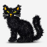 Decorative black sitting cat figurine, 34 cm, perfect for party decor, by Flying Tiger Copenhagen, displayed on a surface.
