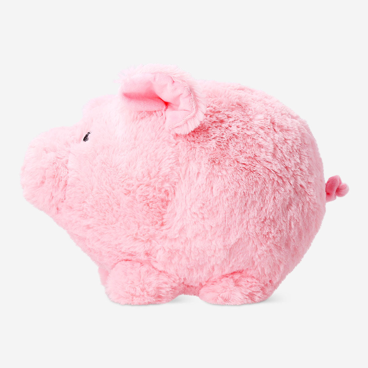 Soft plush piggy bank toy from Flying Tiger Copenhagen, featuring a cute pig design with a coin slot on its back.