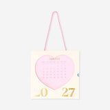 Pink heart-themed hanging monthly calendar for 2027, designed for office use, by Flying Tiger Copenhagen.