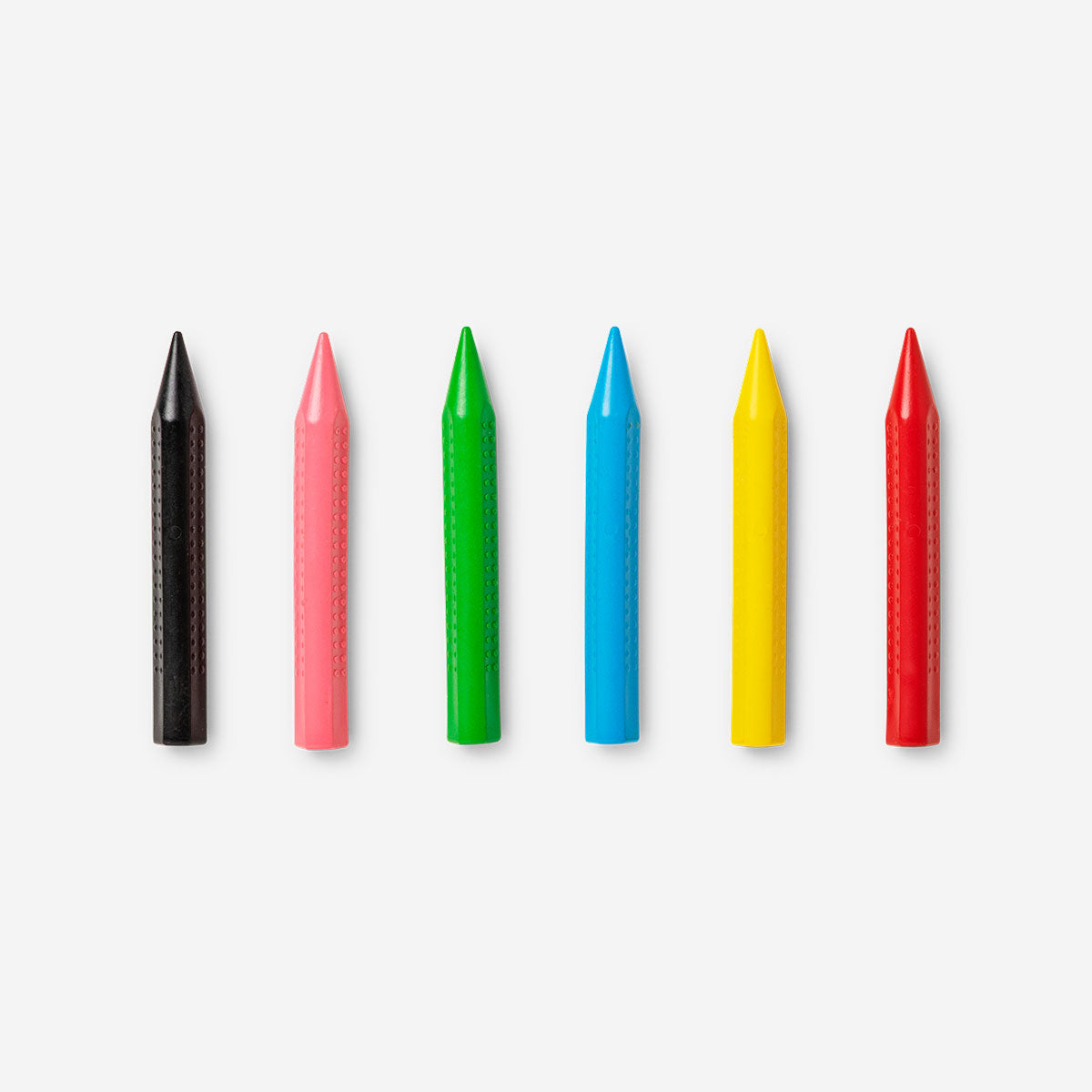 Set of six colorful Hobby Crayons from Flying Tiger Copenhagen arranged in a row.