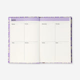 A5 floral study planner by Flying Tiger Copenhagen featuring a colorful floral cover and weekly planner pages for office use.