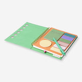 Green Flying Tiger Copenhagen office notebook with ballpoint pen and memo notes on a desk.