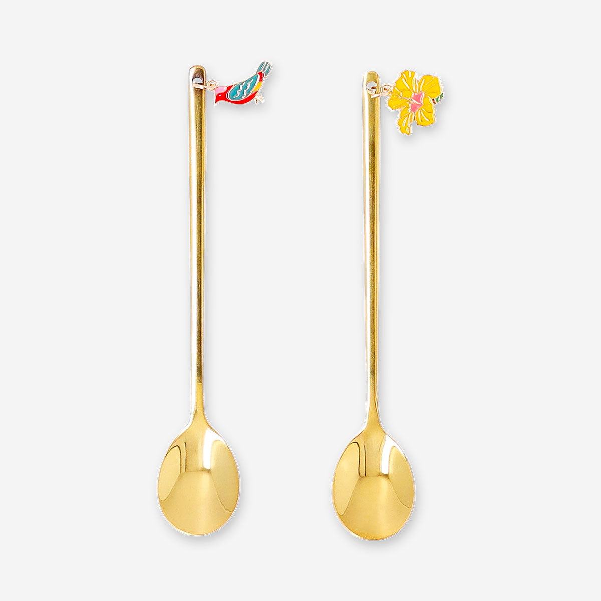 Two gold dessert spoons with tropical flower decorations, Flying Tiger Copenhagen kitchenware, showing intricate floral details.