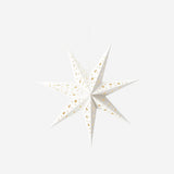 White glowing paper star home decor by Flying Tiger Copenhagen, illuminated and hanging as a decorative light.