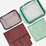 Set of five Flying Tiger Copenhagen leisure organiser bags for travel, showing colorful, compact storage pouches in a variety of sizes.