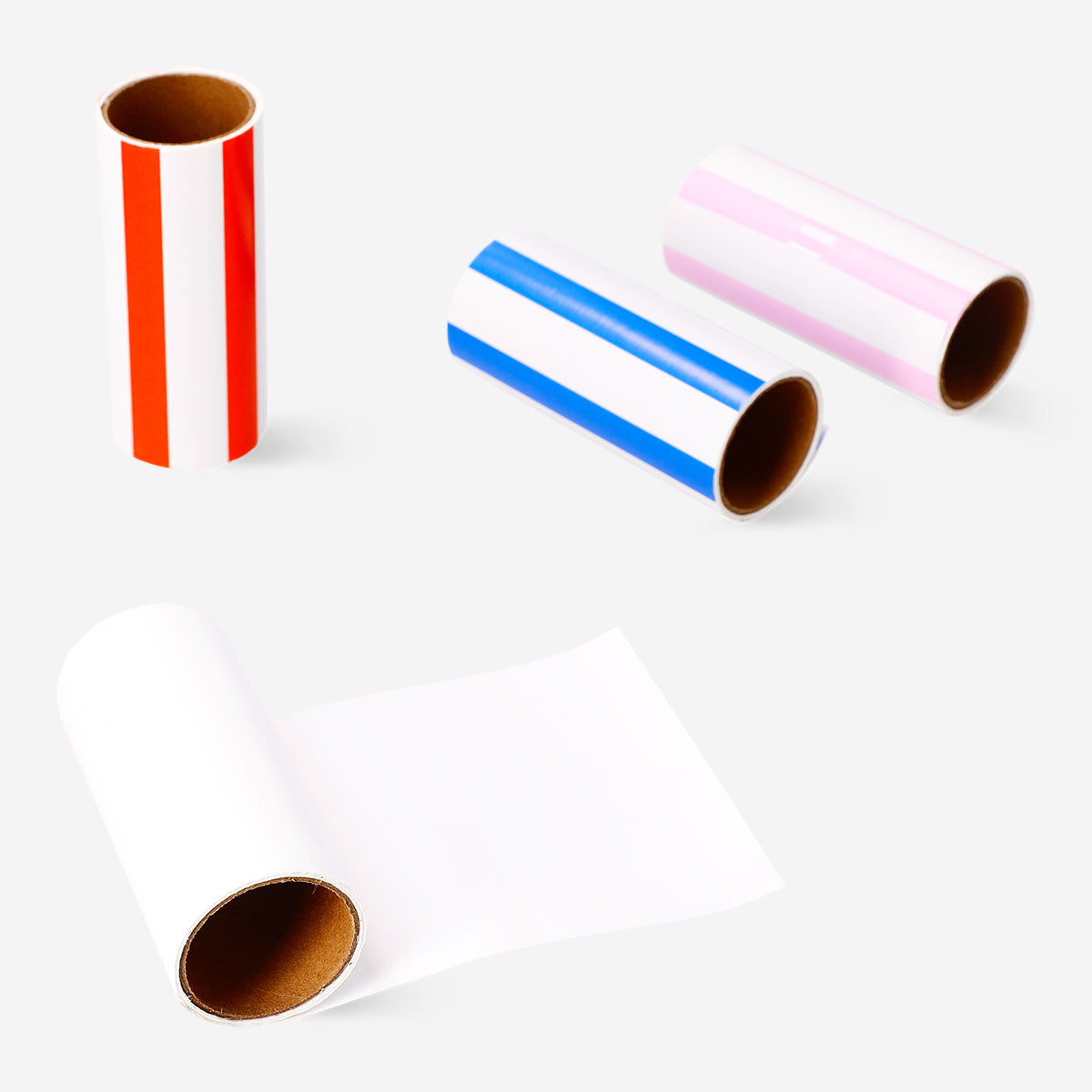 Four Flying Tiger Copenhagen lint roller refills with adhesive sheets for removing lint and pet hair from clothing and fabrics.