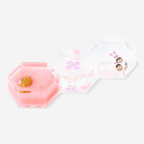 Decorative gadget hourglass by Flying Tiger Copenhagen featuring candy monster icon designs in clear glass.