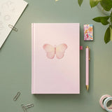 Flying Tiger Copenhagen A5 butterfly bullet planner with pen and magnetic bookmark, open to show colorful planner pages.