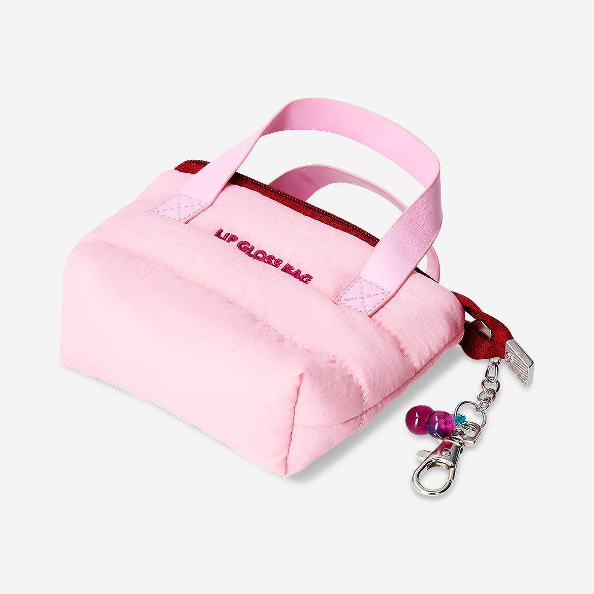 Mini toiletry bag for lip gloss with cherry charm, Flying Tiger Copenhagen personal care accessory in soft fabric with zipper closure.
