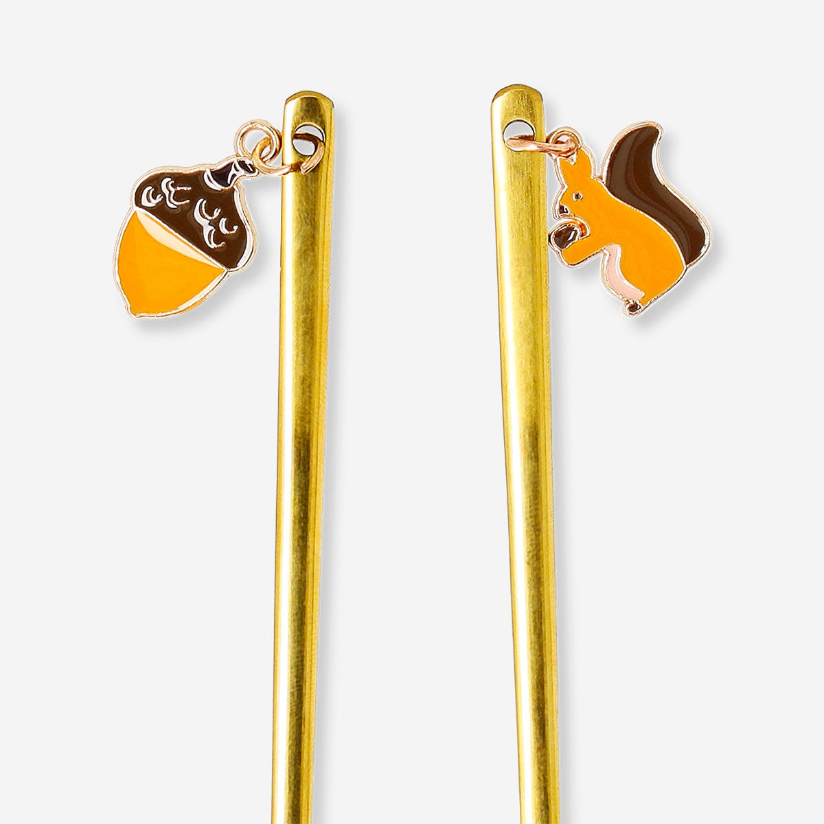 Set of two Flying Tiger Copenhagen gold dessert spoons with acorn and squirrel decorative handles, perfect for elegant kitchen use.