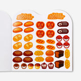 Hobby sticker book featuring bakery-themed stickers with illustrations of bread, pastries, and baked goods by Flying Tiger Copenhagen.