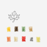 Two DIY stained glass autumn leaves decorations for hanging, crafted by Flying Tiger Copenhagen, featuring vibrant fall colors and intricate details.