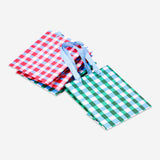 Four checkered gift bags for office use by Flying Tiger Copenhagen, featuring stylish plaid patterns.